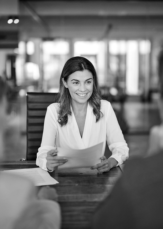 Financial advisor reviewing documents with a client during a personal consultation.